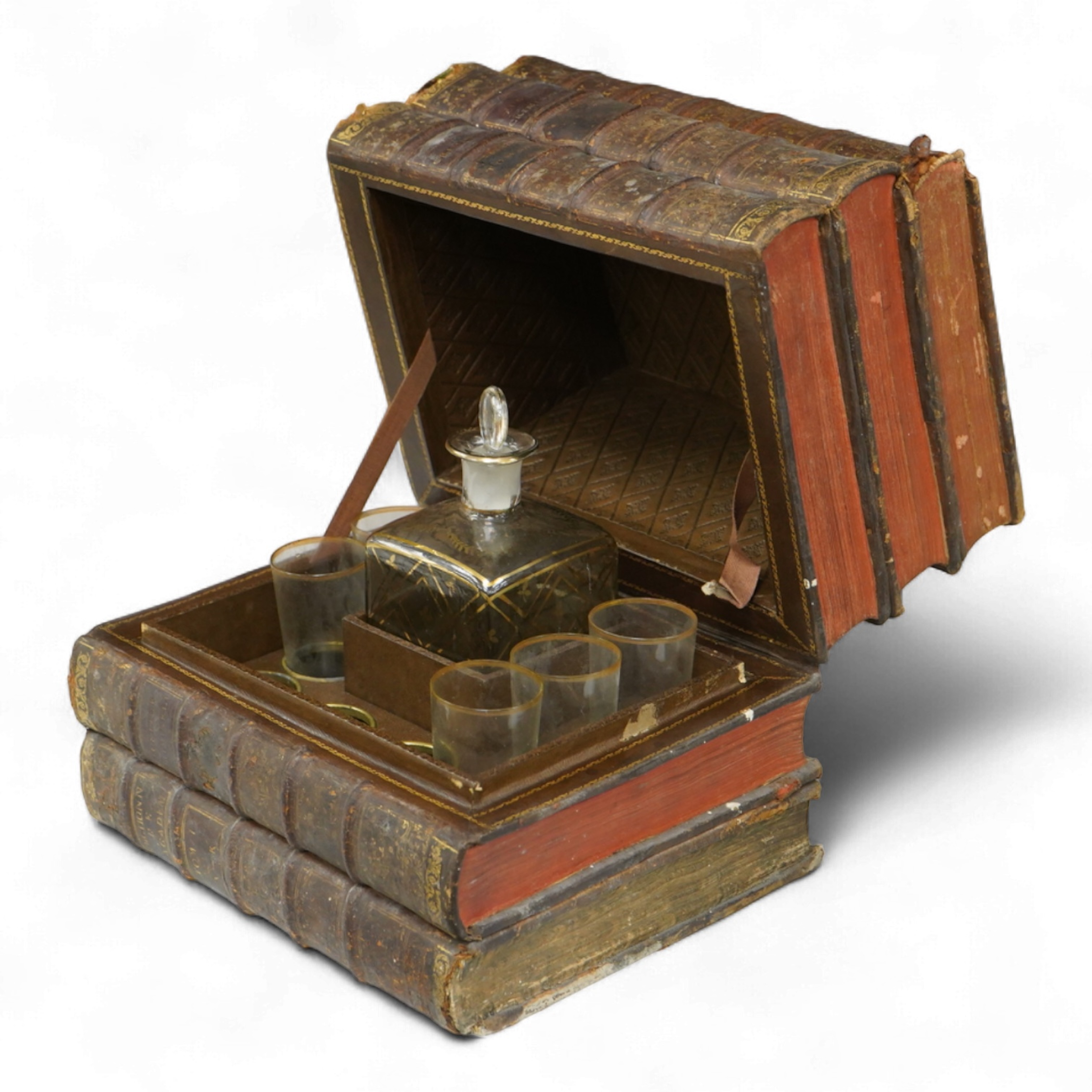 A novelty stack of books liqueur set, the contents including, decanter with stopper and five glasses, 26cm wide x 23cm high